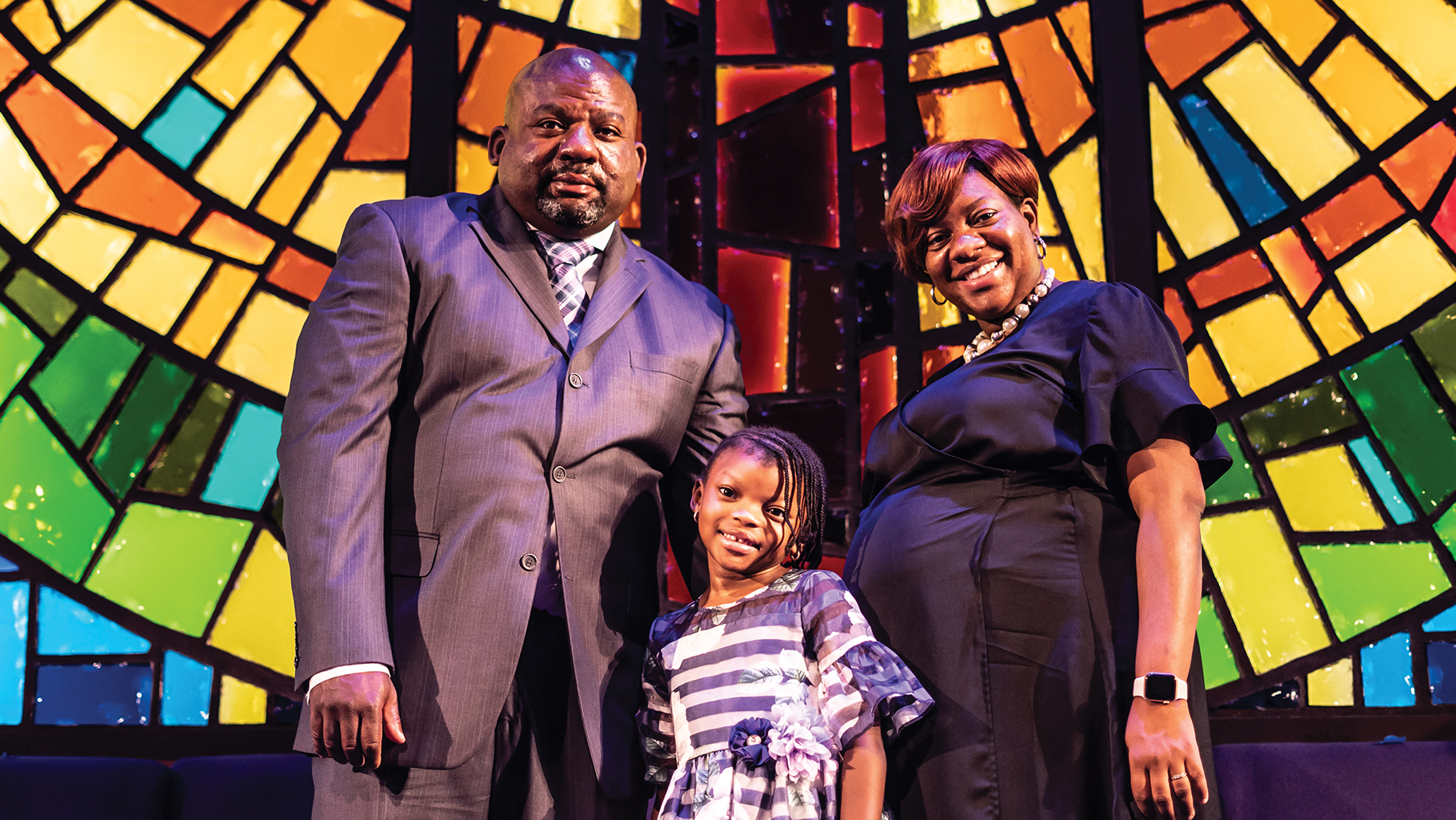 Modestine Davis stands before the church’s artful stained glass with her husband, Rev. George, and 6-year-old daughter, Isabella. “First Baptist Church of Highland Park just meets all of our spiritual needs and wraparound service needs in terms [of] family, children’s church, ministries that are strong,” Davis said.