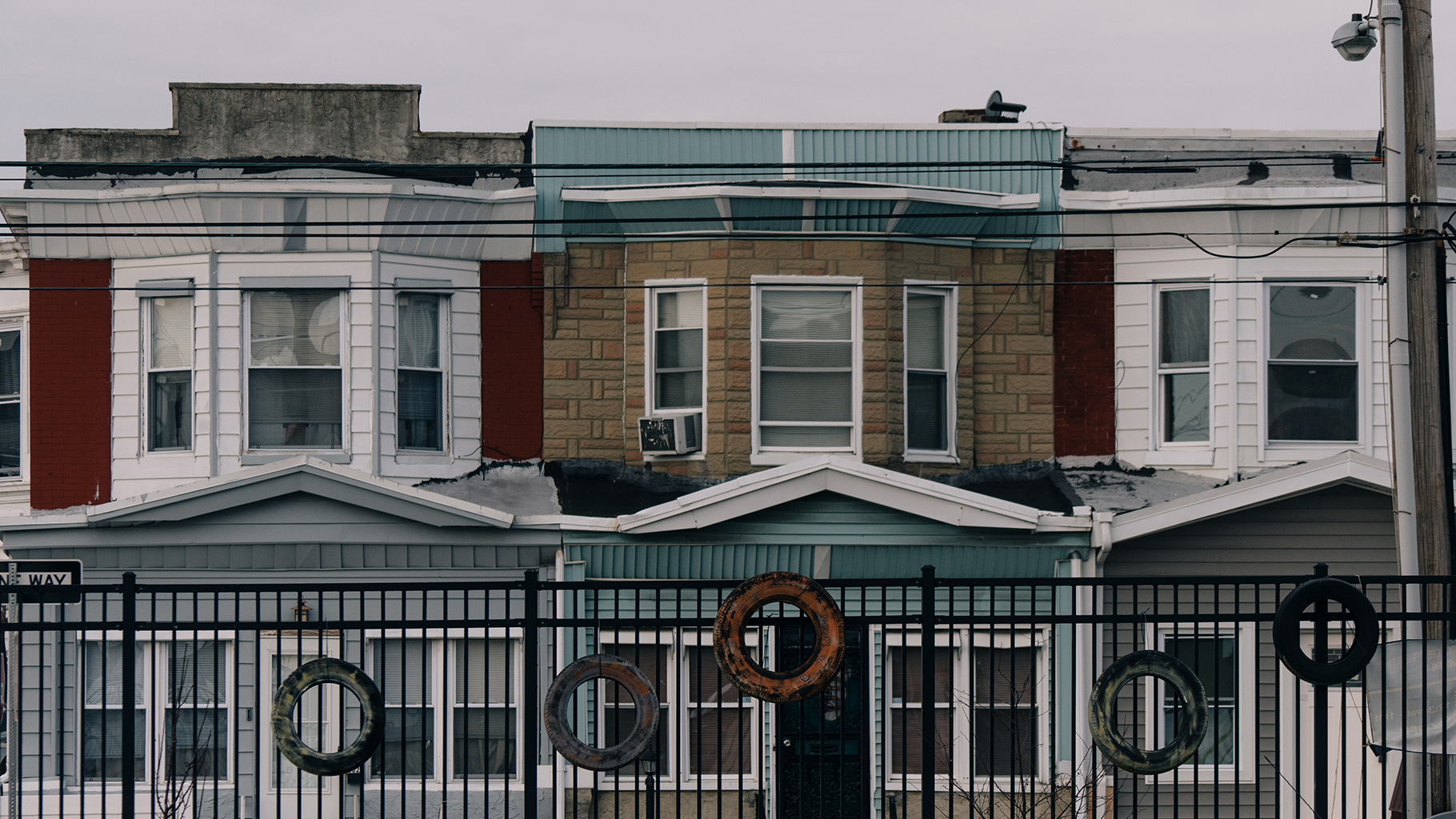 Row houses line a street in West Philadelphia, a neighborhood with a high percentage of tangled titles.