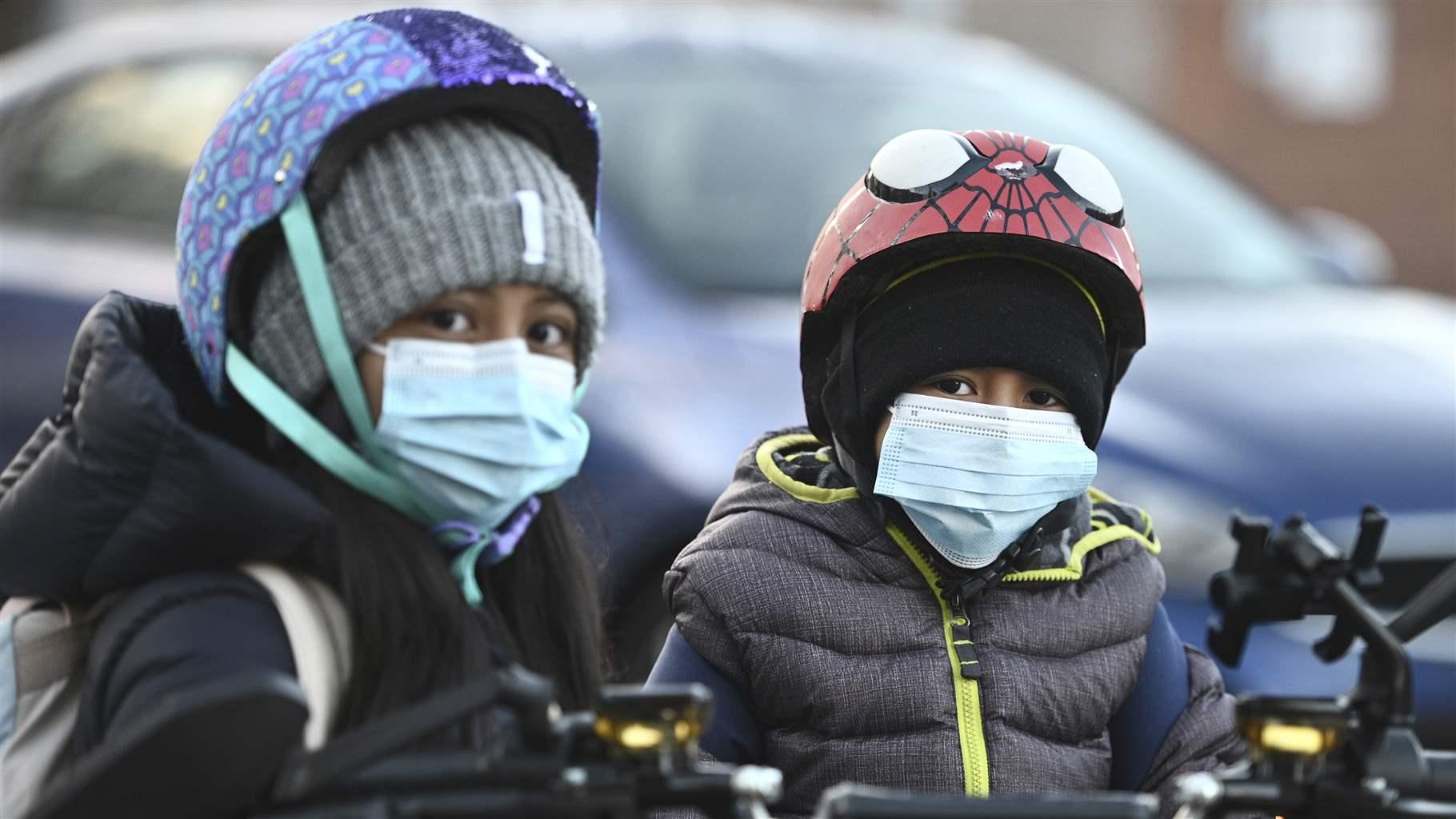 Two children wearing masks Two children wearing masks